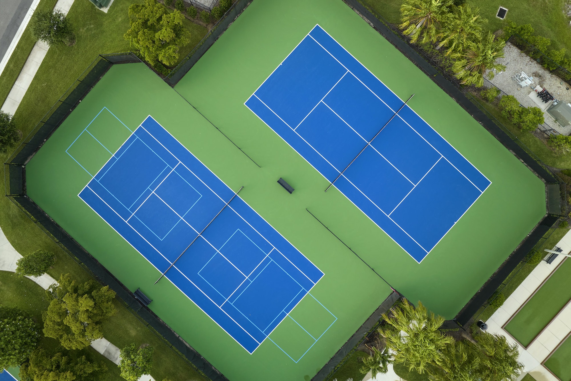 Aerial view of blue tennis courts for sports recreational activity